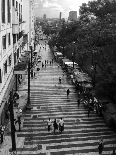 Foto em preto e branco de calçadão com escadaria cheia de pedestres